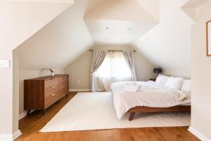 a bedroom with a bed and a window at Modern & Spacious 1908 Home in Stratford