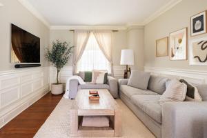 a living room with a couch and a coffee table at Modern & Spacious 1908 Home in Stratford