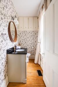 a bathroom with a sink and a mirror at Modern & Spacious 1908 Home in Stratford +26 photos
