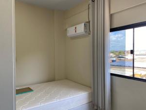 a small room with a bed next to a window at Pousada do Leo in Olinda