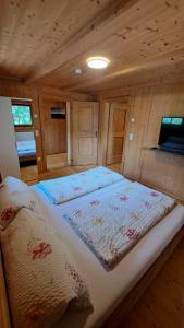 a large bed in a room with a wooden ceiling at Ferienhaus Berger in Virgen