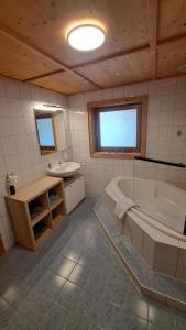 a large bathroom with a tub and a sink at Ferienhaus Berger in Virgen +21 photos