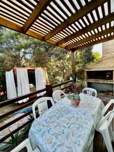a table and chairs under a pergola on a patio at Posada Agua Marina in La Paloma