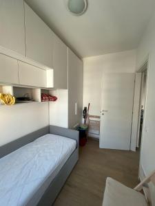 a small bedroom with a bed and a white cabinet at VARIE STRUTTURE Queste strutture NON FORNISCE lenzuola da letto e asciugamani in Lido Adriano