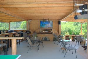 a large room with tables and chairs and a flat screen tv at Ilias Apartments in Ipsos