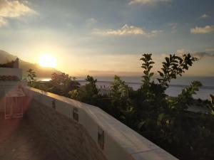 a sunset over the ocean from a balcony at Casa Emi in Amalfi