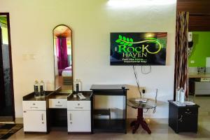 a room with a table and a sign on the wall at Rock Haven Wayanad Resort and Experiences in Kalpetta
