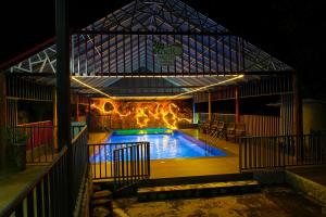 a swimming pool in a building at night at Rock Haven Wayanad Resort and Experiences in Kalpetta