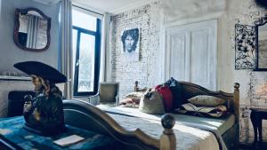a bedroom with a bed with a statue of a woman holding an umbrella at Legions Retreat in Antwerp