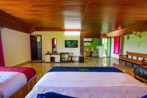 a bedroom with two beds and a living room at Rock Haven Wayanad Resort and Experiences in Kalpetta +83 photos