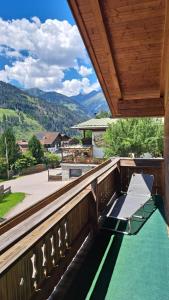 a balcony with a bench and a view of the mountains at Ferienhaus Berger in Virgen