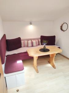 a living room with a couch and a wooden table at Haus Enzian in Mittersill