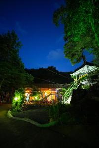a playground lit up at night with lights at Rock Haven Wayanad Resort and Experiences in Kalpetta