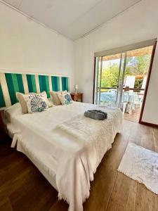 a bedroom with a large bed with a large window at Posada Agua Marina in La Paloma +240 photos