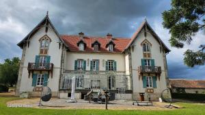 a large house with two large windows at Chambre Napoléon III in Fleuriel