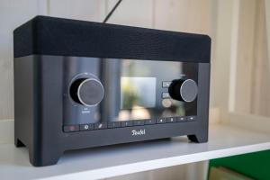a small black microwave sitting on a table at Skandi Design Ferienhaus mit Hafenblick & Beach in Wandlitz
