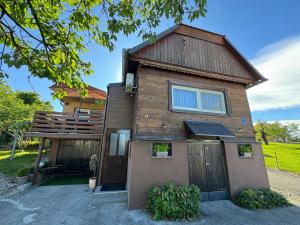 a wooden house with a door and a fence at House Sweet stay by Deda Ferda late self check in in Draganići