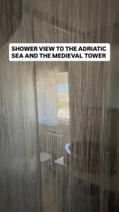 a shower view to the archaic sea and the medical tower at BELLE HOME OSTUNI vasca vista mare in Ostuni