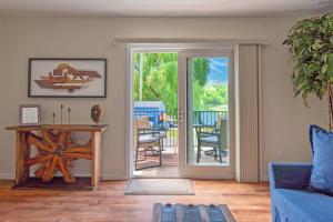 a living room with a door leading to a patio at Saugerties Waterfront Getaway in Saugerties