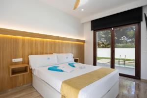 a bedroom with a large bed with a large window at Fely Sea Villa in Novo Sancti Petri +23 photos