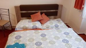 a bed with orange and blue pillows on it at Get Prague Flat Slovenska in Prague