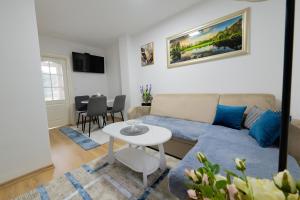 a living room with a couch and a table at Golden Lake House in Konjic