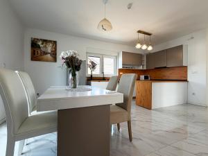 a kitchen and dining room with a table and chairs at Vila Gaia in Sarajevo