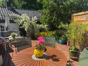 a patio table with a vase of flowers and fruit on it at Villa house in Son Old Town - Oslo Fjord in Vestby