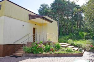 a house with stairs and flowers in a garden at Dom na Wynajem Gdynia Grabówek in Gdynia