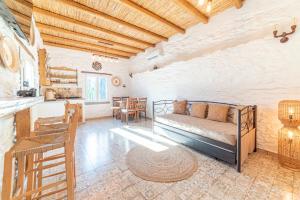 a living room with a couch and a table at Aloni Houses Kythnos in Loutra