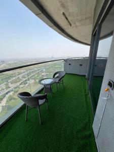 three chairs and a table on the top of a building at Luxurystay-supernova in New Delhi