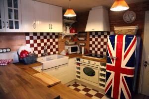 a kitchen with an british flag on the refrigerator at Old England House in Minas de Ríotinto