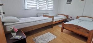 a bedroom with two beds and a window at 2 BDR Family Apartment In Sarajevo - Free Parking in Sarajevo