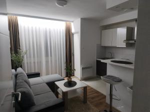 a living room with a couch and a table at Apartman Škribulja in Županja