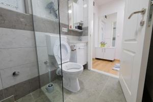 a bathroom with a toilet and a glass shower at Golden Lake House in Konjic +64 photos