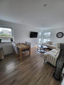 a living room with a table and a couch at Quayside Waters in Dundee