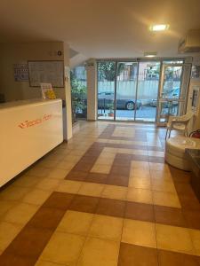 an office lobby with a reception counter and glass doors at Tropics Hotel by Aleksis in Sveti Vlas +36 photos