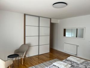a bedroom with a bed and a table and a chair at Villa Vildana in Sarajevo