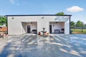 a large white garage with a fountain on a patio at Korovosoto Lodge in Dallas