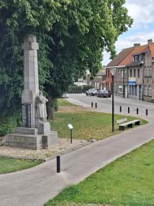 a statue in the middle of a street at De Reünie - airconditioned duplex appartement & fietsgarage in Langemark