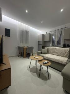 a living room with a couch and a table at Makridakis apartments in Rethymno