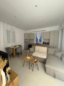a living room with a couch and a table at Makridakis apartments in Rethymno