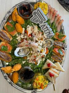 a platter of seafood and other foods on a table at Atena B&B APARTMENTS Platino in San Silvestro
