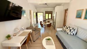 a living room with a couch and a table at Edem Haven Luxury Apartment in Skala Fourkas