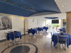 a dining room with blue tables and chairs at Blue Star Hotel in Lima