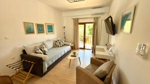 a living room with a couch and a table at Edem Haven Luxury Apartment in Skala Fourkas