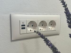a white light switch with three discs on it at Iža na brejgi in Moravske-Toplice +27 photos