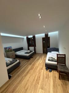 a room with two beds and a chair in it at Guesthouse Dritan Selimaj in Valbonë