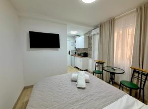 a bedroom with a bed with two towels on it at Alteagroup Joy in Altea