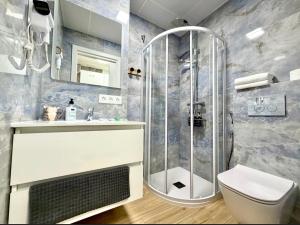 a bathroom with a shower and a toilet and a sink at Alteagroup Joy in Altea +41 photos